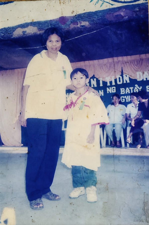 Young Leopoldo with his mother at a school recognition day